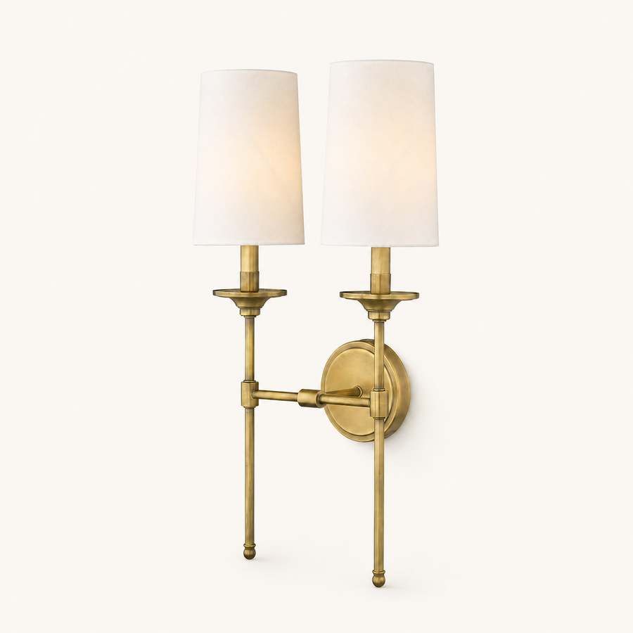 Front | two-light rubbed brass wall sconce with two off-white linen shades on a round backplate