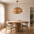 Scale | full honey-tan three-tier chandelier hanging above a round oak table beside a full-height doorway