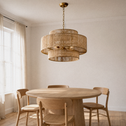 Room 1 | honey-tan three-tier rope chandelier hanging over a round oak dining table with a gold chain