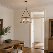 Scale | chandelier hanging beside an uncropped full-height doorway for scale