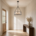 In a room | entryway view of the chandelier hanging beside a full-height door and walnut console