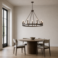 In scale | oil-rubbed bronze chandelier with an uncropped tall doorway at left