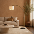 Room 2 | arched floor lamp beside an oatmeal sofa in a terracotta room