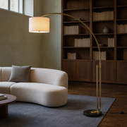 Room 3 | arched floor lamp beside a cream sofa in a sage library