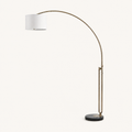 Studio front | full antique-brass arc, off-white cotton drum, and black marble base