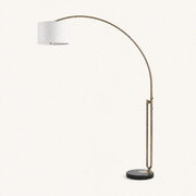 Studio front | full antique-brass arc, off-white cotton drum, and black marble base
