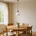 Dining room | brushed nickel and frosted opal glass pendant centered over a round oak dining table with four oak chairs