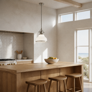 Coastal kitchen | brushed nickel and frosted opal glass pendant over a warm oak island in a sunlit kitchen