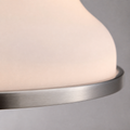 Texture close-up | frosted opal glass bell shade meeting the thin brushed nickel lower rim