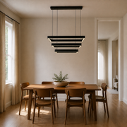 Scale | black three-tier rectangular chandelier in a dining room with a full-height doorway