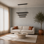 Cool limewash living room view | black three-tier rectangular LED chandelier above a travertine coffee table