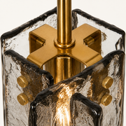 Hardware | close view of the brass cross bracket holding the glass panels
