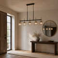 Entry | the same pendant hung lengthwise above an entryway console table with a round mirror