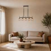Living room | the pendant centered lengthwise above a round travertine coffee table