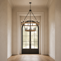 Scale | light woodgrain 20-light chandelier hanging within a full-height entry doorway