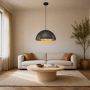 In a living room | the dome pendant hanging over a round stone coffee table