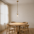 Dining room angle | second view of the single clear glass vase pendant over a round table