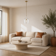 Living room | single clear glass vase pendant above a round travertine table