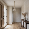 Entryway | single clear glass vase pendant in a greige limewash entry