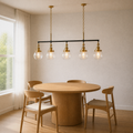 Three-quarter dining-room view | five-globe pendant over a round wood table