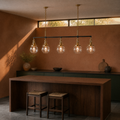 In a terracotta kitchen | five-globe pendant above a walnut island