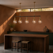 In a terracotta kitchen | five-globe pendant above a walnut island