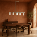 Terracotta dining room | brushed nickel 5-light linear pendant over a walnut table