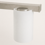 Glass and finish | close view of white frosted glass, nickel cap, and brushed bar grain