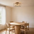Room | natural brass star flush mount over a round oak dining table