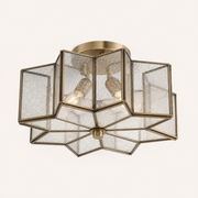 Studio angle | lower view of the brass canopy, seeded glass panels, and finial