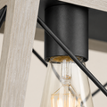 Close up | graphite-black socket, clear bulb, X brace, and whitewashed wood rail