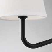Hardware detail | black socket, short stem, white shade edge, and smooth curved arm