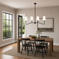 At scale | black four-arm pendant over a table with a full-height doorway and window reveal