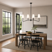 At scale | black four-arm pendant over a table with a full-height doorway and window reveal