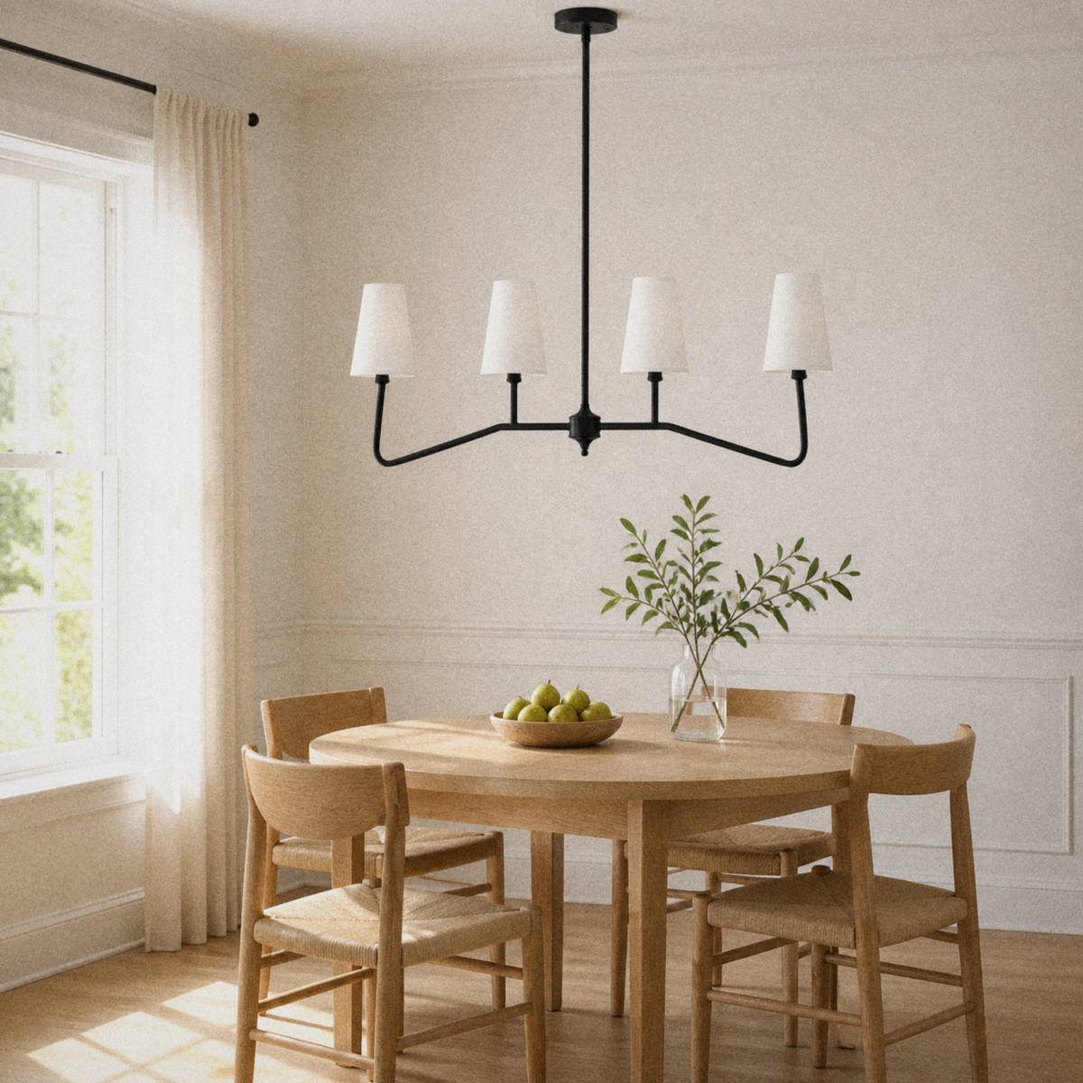 Dining room | black four-arm pendant with four white woven fabric shades above a pale-oak table
