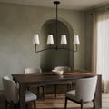 Cool dining room | black four-arm pendant with white fabric shades above a dark walnut table