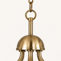 Hardware detail | close view of warm brass central hub, stem, ring, and chain links with partial curved arms