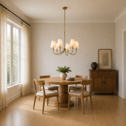 Scale | small six-light warm brass chandelier in a full-height dining room with window reveal