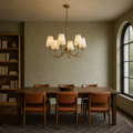 Library dining room | six-light warm brass chandelier with six ivory linen shades above a dark walnut table