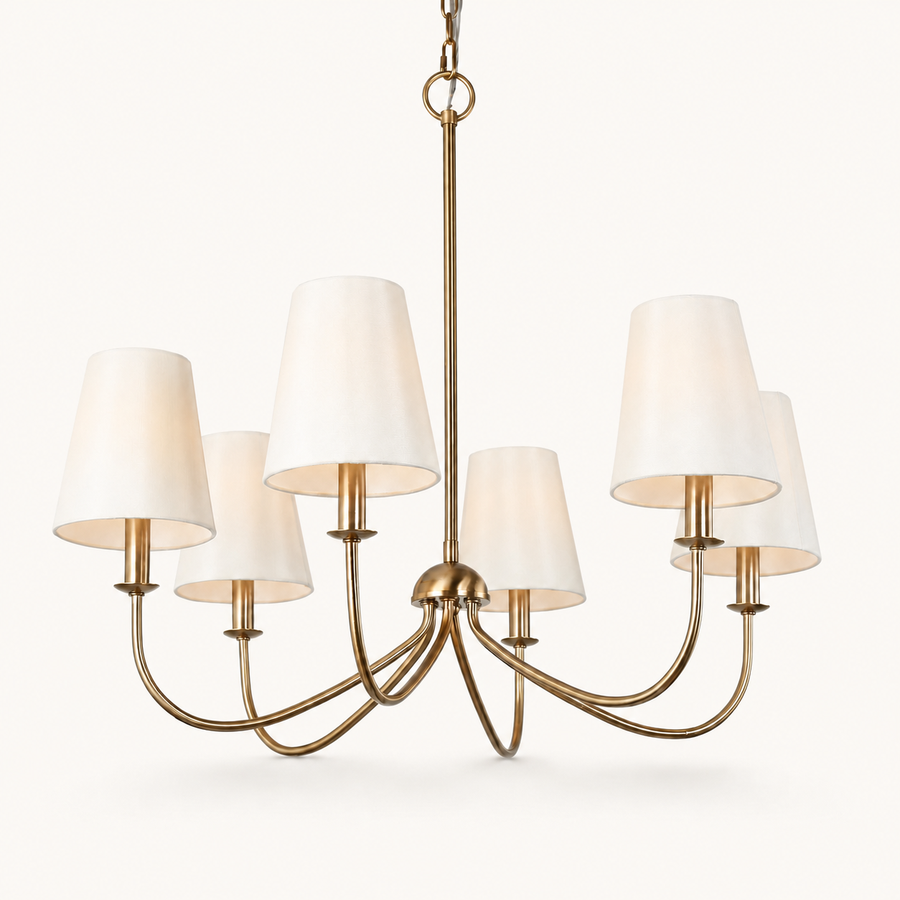 Front | six-light warm brass chandelier with six ivory linen shades, chain, and canopy on white