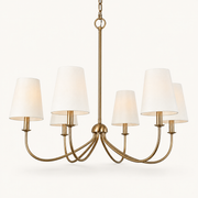 Studio three-quarter | warm brass six-arm chandelier with six ivory shades and chain
