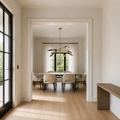 Scale view | eight-light chandelier hanging beyond an uncropped full-height doorway reveal