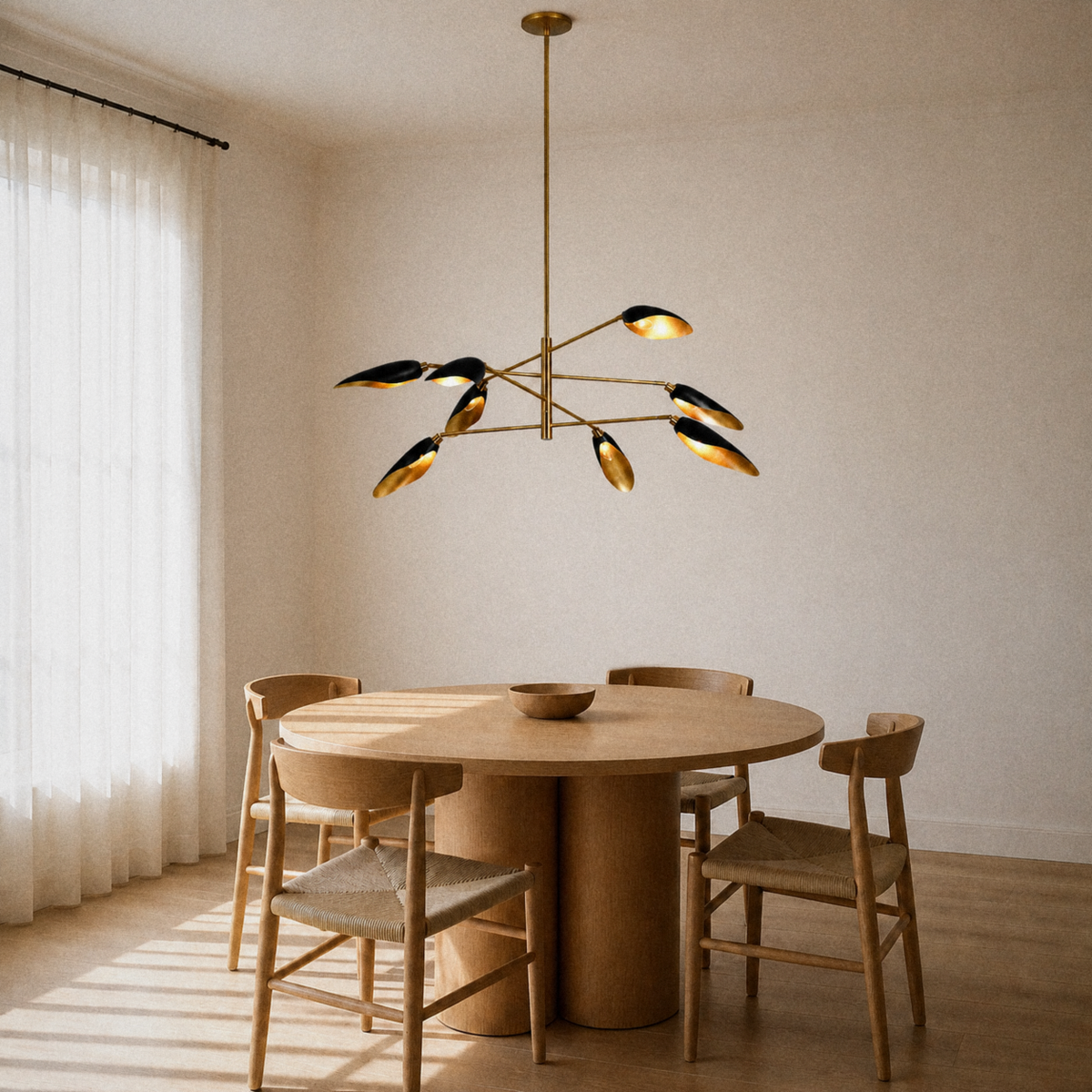 Dining room | eight matte-black cone shades with light-gold interiors on four brass arms over a round oak table
