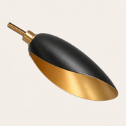Close-up | matte-black cone shade exterior, light-gold interior and brass collar