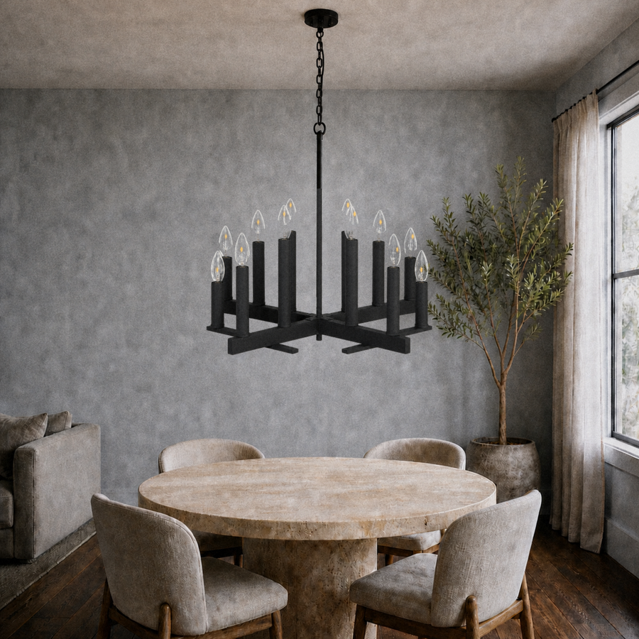 Cool blue-gray dining room | dark aged-zinc 12-light open X-frame chandelier above a round travertine table
