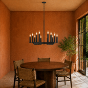 Terracotta dining room | dark aged-zinc 12-light chandelier above a round walnut table