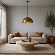 Living room | hammered gold dome pendant above a round limestone coffee table
