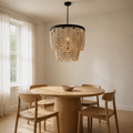 In a room | warm dining room with a cream wood-bead chandelier hanging over a round oak table