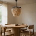 Angle | second dining-room angle of the cream wood-bead chandelier above a round oak table