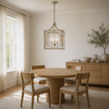 In a room | antique silver three-light open lantern pendant over a pale oak dining table